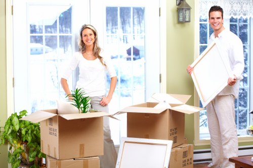 Movers handling furniture during a Tottenhamgreen home relocation
